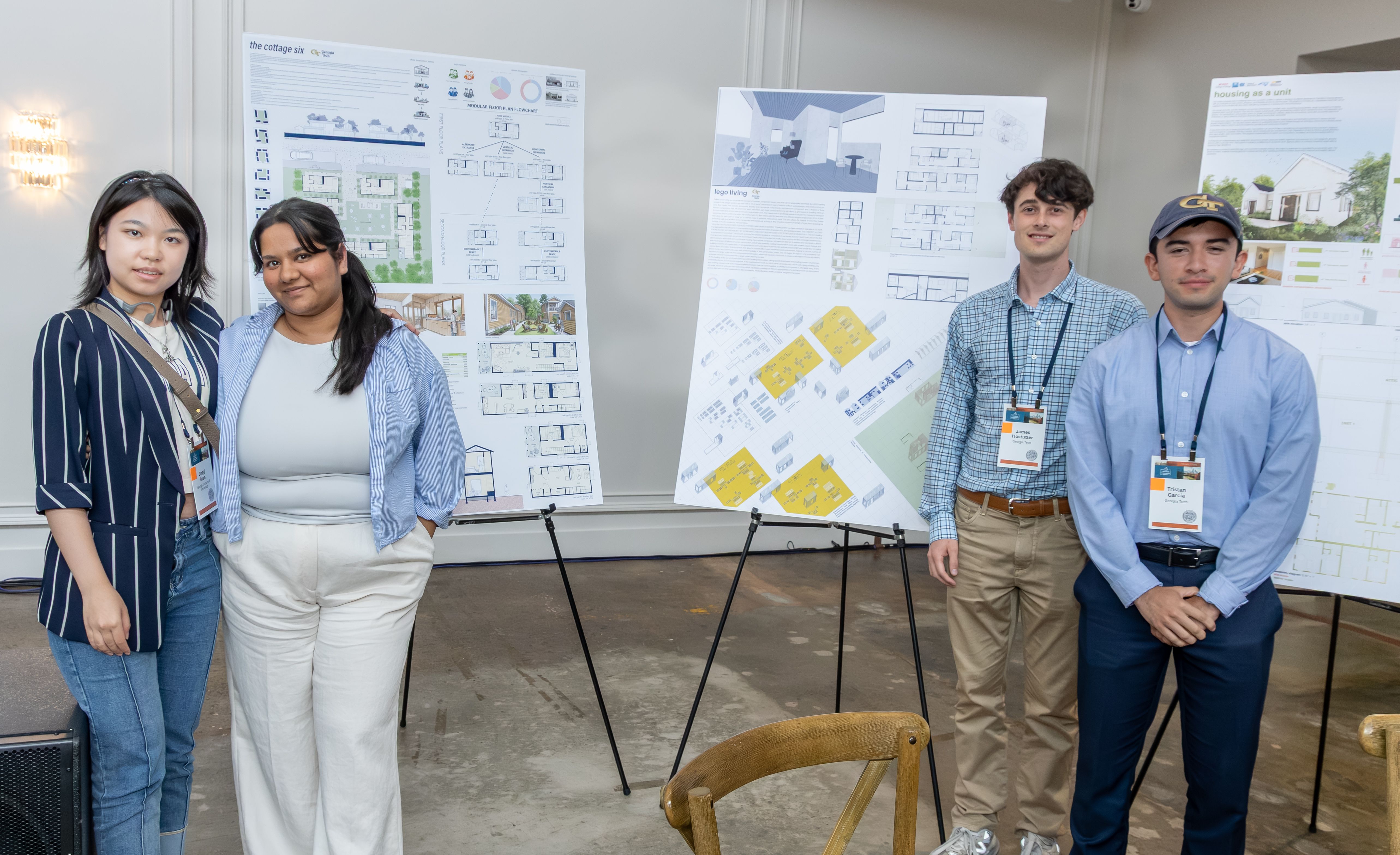 Polished group photo of four students from the Georgia Tech Solar Decathlon team, smiling and posing in front of a 'Housing Innovation Summit 2026' banner. They are wearing matching team polos and holding a 'FINALIST' certificate.